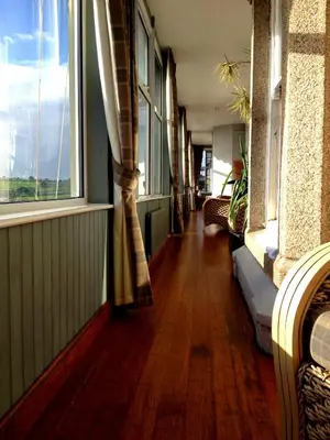 a hallway with windows and a hard wood floor at Membly Hall Hotel in Falmouth