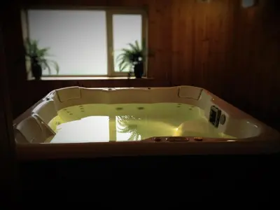 a white bath tub in a bathroom with a window at Membly Hall Hotel in Falmouth