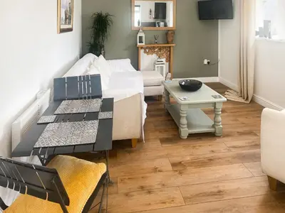 a living room with a couch and a table at Chi Lowen in Camborne