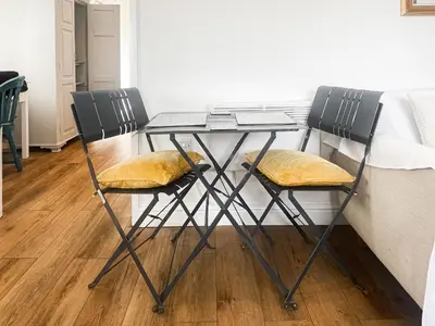 a table with two chairs next to a bed at Chi Lowen in Camborne