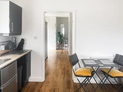 a kitchen and dining room with a table and chairs at Chi Lowen in Camborne