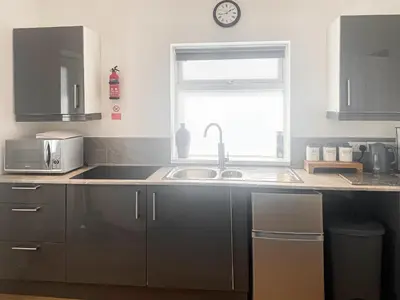 a kitchen with a sink and a window at Chi Lowen in Camborne