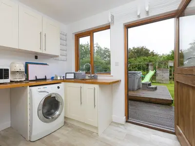 a kitchen with a washer and dryer in a house at Branock, Tor Down Quarry in Bodmin