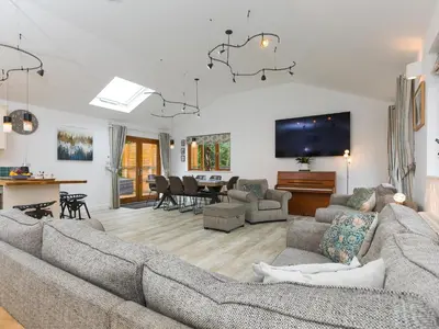 a living room with a couch and a dining room at Branock, Tor Down Quarry in Bodmin