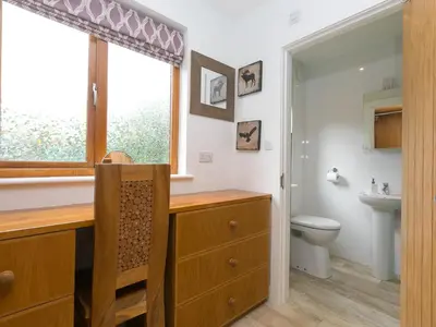 a bathroom with a sink and a toilet and a window at Branock, Tor Down Quarry in Bodmin