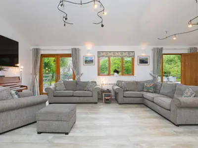 a living room with two couches and a tv at Branock, Tor Down Quarry in Bodmin