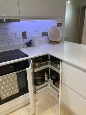 a kitchen with a white counter top with an open drawer at Acuba in Falmouth