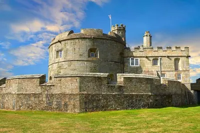 an old castle sitting on top of a grass field at Acuba in Falmouth