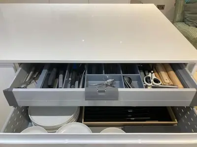 a drawer filled with scissors and other tools at Acuba in Falmouth