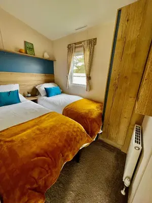 two beds in a room with two beds sidx sidx sidx at Newquay Bay Resort - Summer Days 135 in Porth