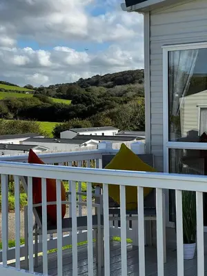 a porch with a white railing and a house at Newquay Bay Resort - Summer Days 135 in Porth