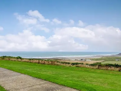 a view of the ocean from a road at Zephyr's View in Poundstock