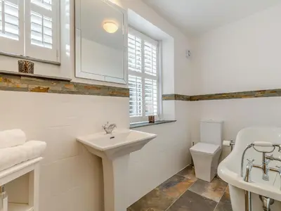 a white bathroom with a sink and a toilet at Ivy Mount in Uny Lelant