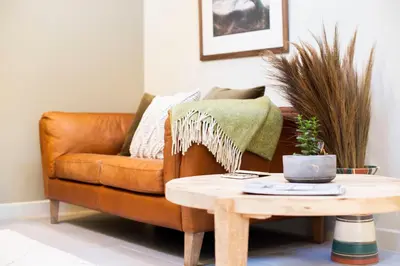 a living room with a couch and a coffee table at Mowhay Barn in Bodmin