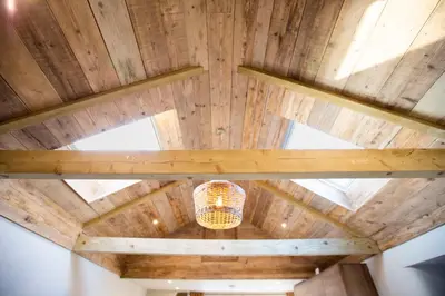 a chandelier hanging from a wooden ceiling in a room at Mowhay Barn in Bodmin