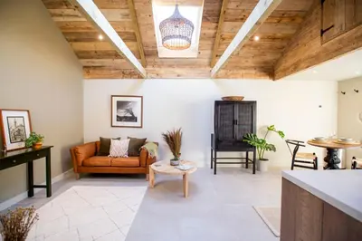 a living room with a couch and a table at Mowhay Barn in Bodmin