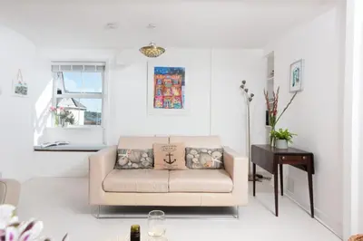 a living room with a couch and a table at Rosevean in Marazion