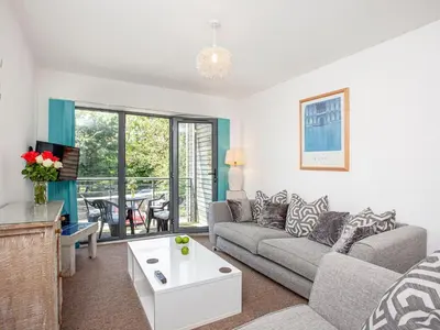 a living room with a couch and a table at 4 Water Wheel Apartment in Charlestown
