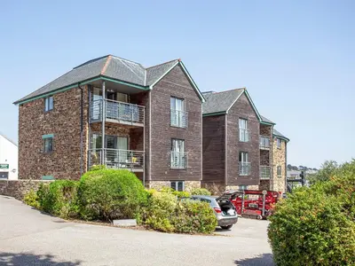 a large brick house with a car parked in front of it at 4 Water Wheel Apartment in Charlestown