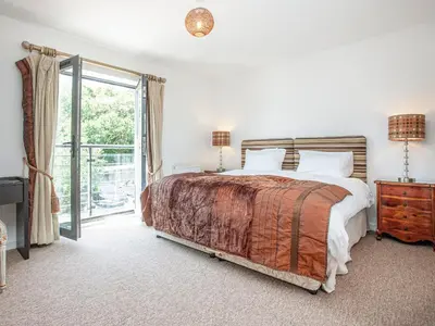a bedroom with a bed and a sliding glass door at 4 Water Wheel Apartment in Charlestown