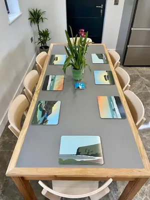a table with pictures and a potted plant on it at Cancleave - Cornish Clifftop Luxury in Bude