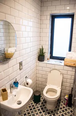 a bathroom with a toilet and a sink at Cancleave - Cornish Clifftop Luxury in Bude