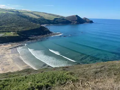 an aerial view of a beach next to the ocean at Cancleave - Cornish Clifftop Luxury in Bude