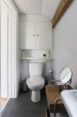 a bathroom with a white toilet and a sink at Hawk's Nest in Wadebridge