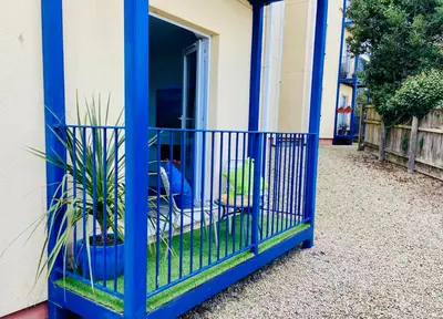 a blue cage with plants in it next to a building at Oceano - Carbis bay, St Ives, 1 bed apartment with free parking near to the beach in St Ives