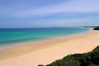 an aerial view of a beach with the ocean at Oceano - Carbis bay, St Ives, 1 bed apartment with free parking near to the beach in St Ives