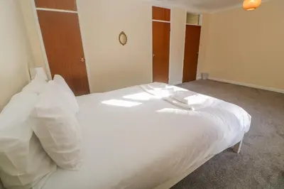 a white bed with white pillows in a room at Yngywidden in Penzance