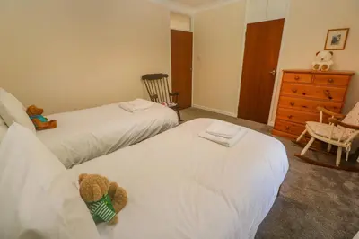 a bedroom with two beds and a dresser at Yngywidden in Penzance