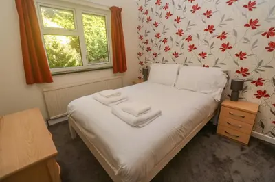 a bedroom with a bed with towels on it at Yngywidden in Penzance