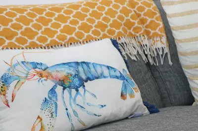 a pillow with a painting of a lobster on it at Stunning home, sea views, walk to beach in Saint Ervan