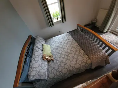 a bedroom with a bed with a teddy bear on it at Looe, Cornwall, couples, families, quiet location, views, reliable Wi-Fi, modern cottage in Looe