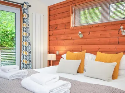 a bedroom with a bed with towels on it at 5 Faraway Fields in Liskeard
