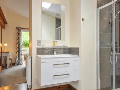 a bathroom with a white sink and a shower at 5 Faraway Fields in Liskeard