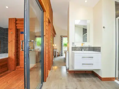 a bathroom with a sink and a mirror at 5 Faraway Fields in Liskeard