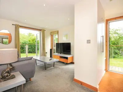 a living room with a couch and a tv at 5 Faraway Fields in Liskeard