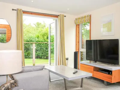 a living room with a flat screen tv and a couch at 5 Faraway Fields in Liskeard