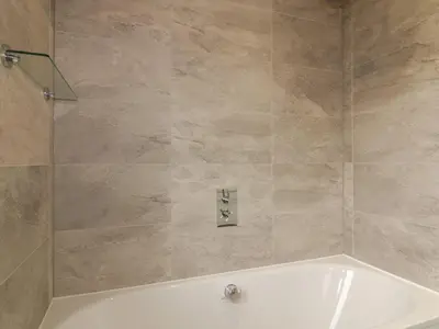a bathroom with a white tub and a shower at 7 Faraway Fields in Liskeard