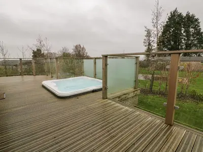 a wooden deck with a swimming pool on top of it at 7 Faraway Fields in Liskeard