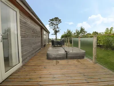 a deck with chairs and a table on a house at 11 Faraway Fields in Liskeard