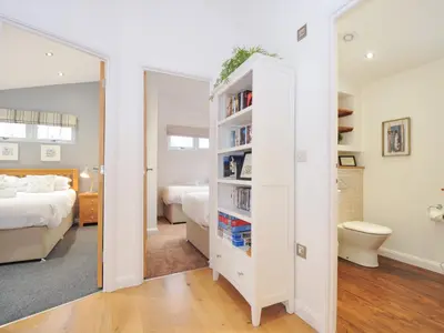 a bedroom with a bed and a book shelf at 15 Faraway Fields in Liskeard