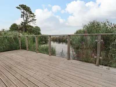 a wooden boardwalk over a body of water at 15 Faraway Fields in Liskeard