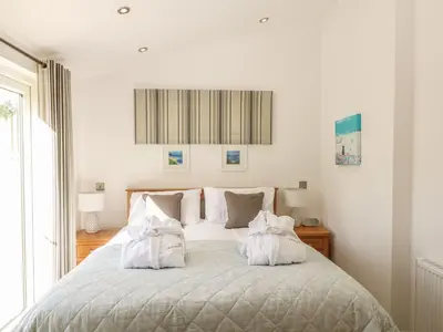 a bedroom with a bed with two white pillows at 14 Faraway Fields in Liskeard