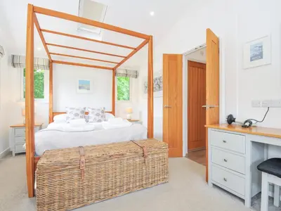 a bedroom with a bed and a large mirror at 1 Horizon View in Liskeard