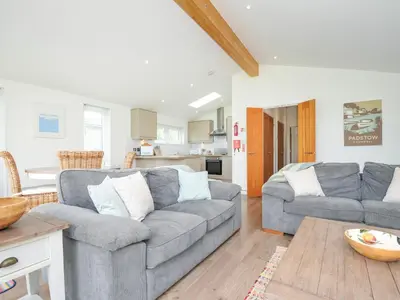 a living room with two couches and a kitchen at 1 Horizon View in Liskeard