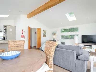 a living room with a table and a couch at 1 Horizon View in Liskeard