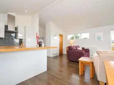 a kitchen and living room with a couch and a table at 3 Horizon View in Liskeard